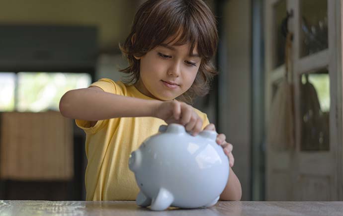 Little boy and a piggy bank